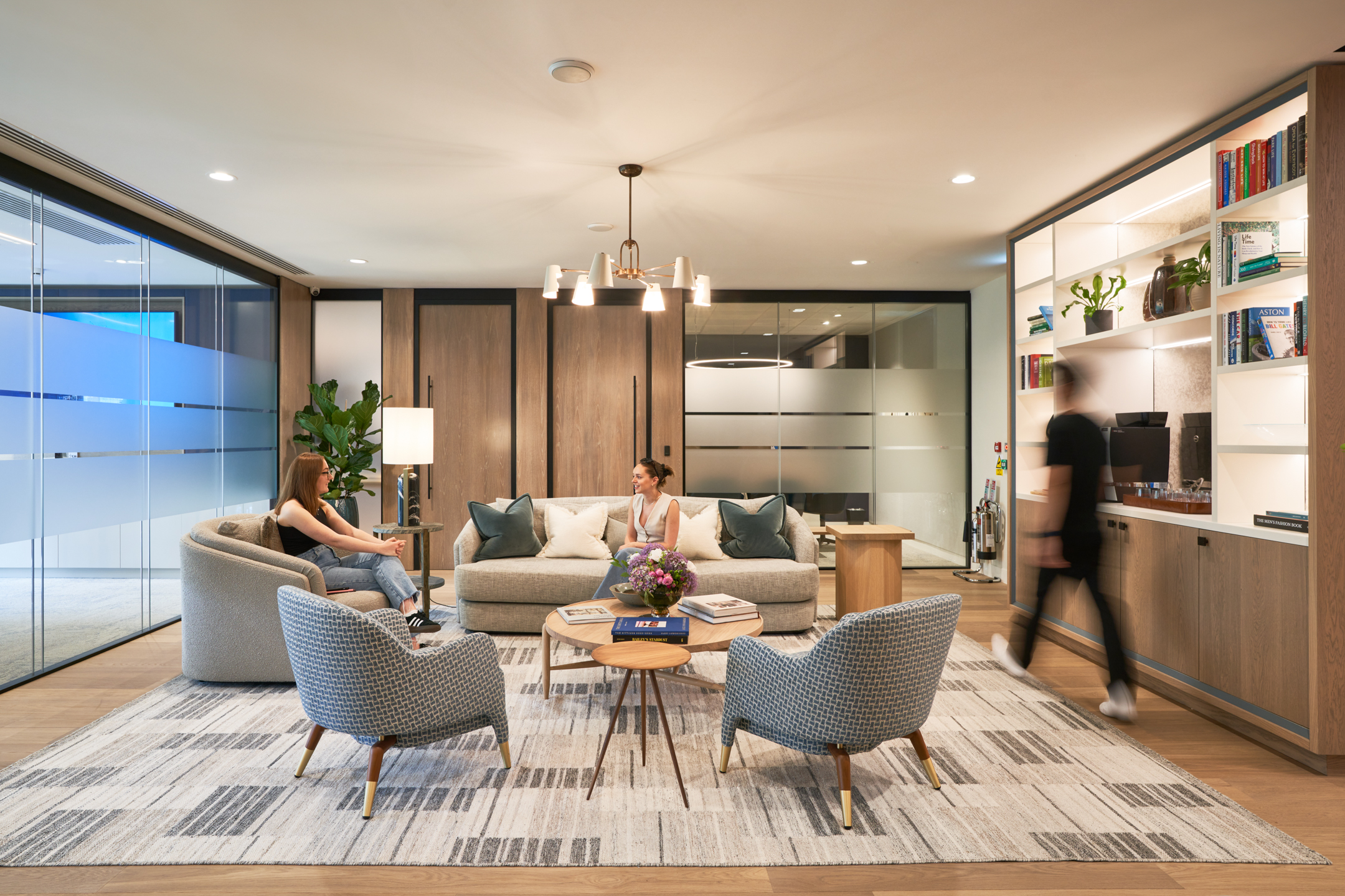 A cozy and modern lounge area at Asset Management Firm, featuring comfortable seating and a sleek design by Modus Workspace.