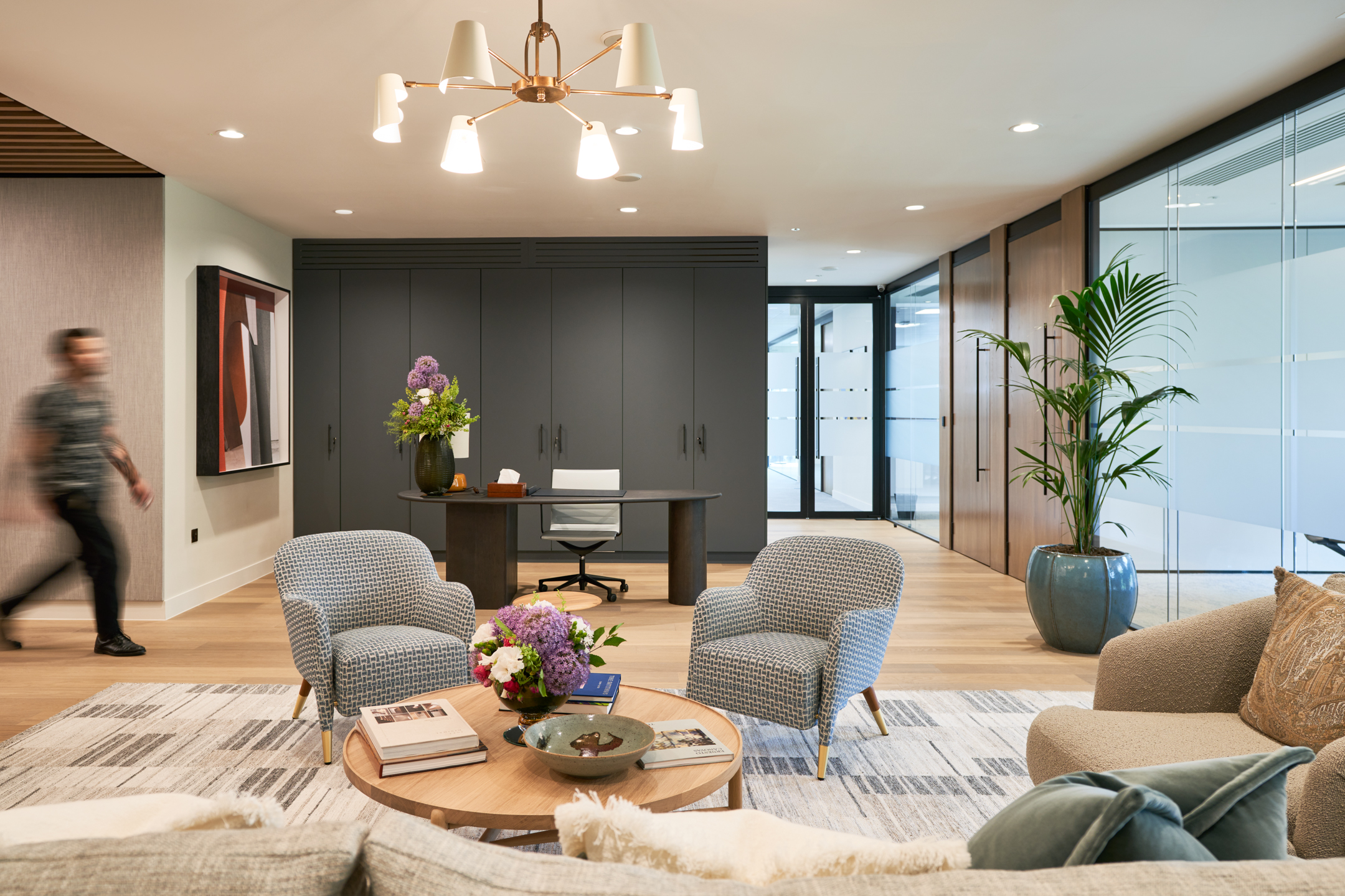 The inviting reception area of an Asset Management Firm, designed with elegant furniture and decor by Modus Workspace.