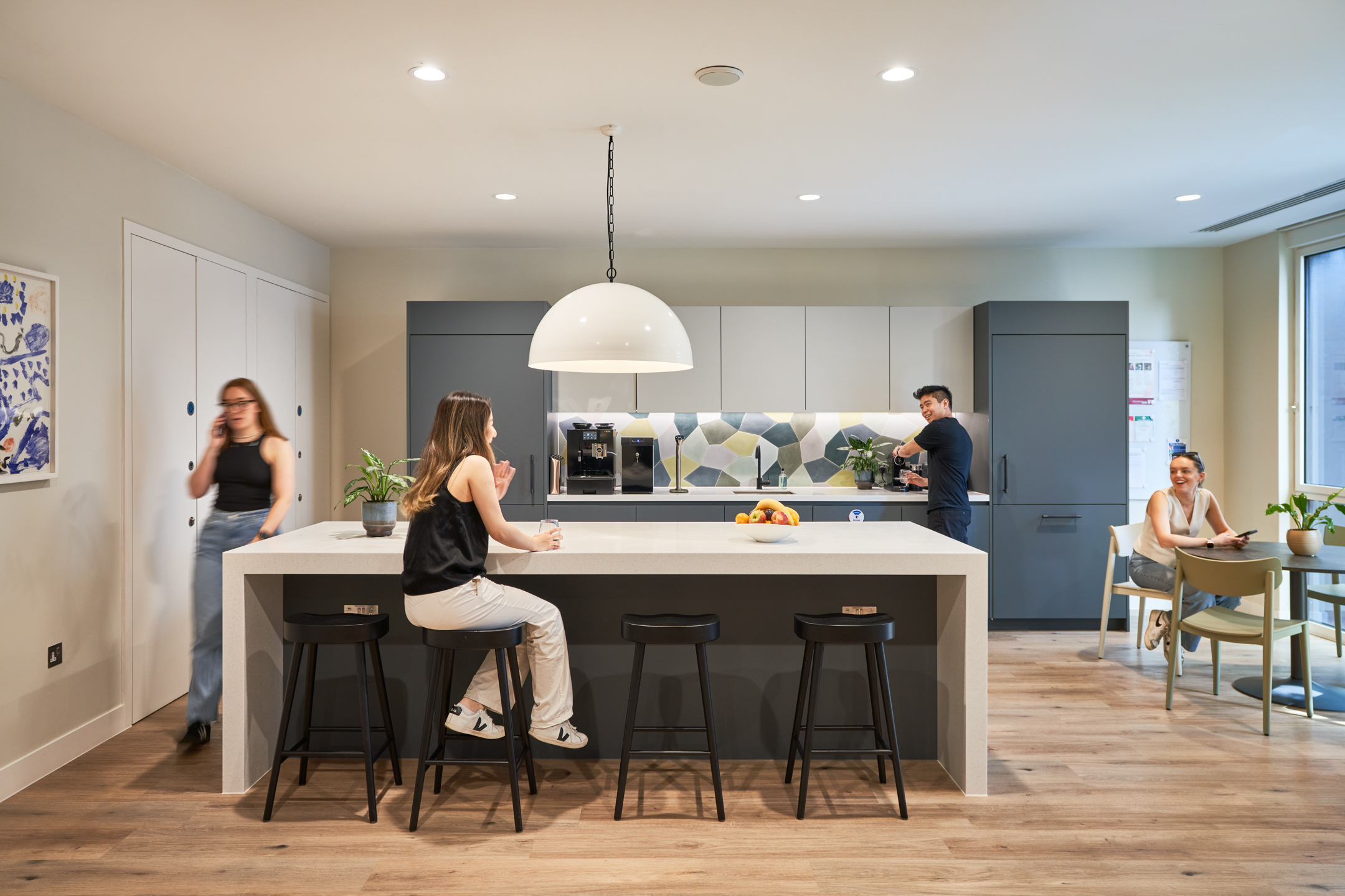 A modern teapoint area at Asset Management Firm, designed by Modus Workspace with functional seating and contemporary style.