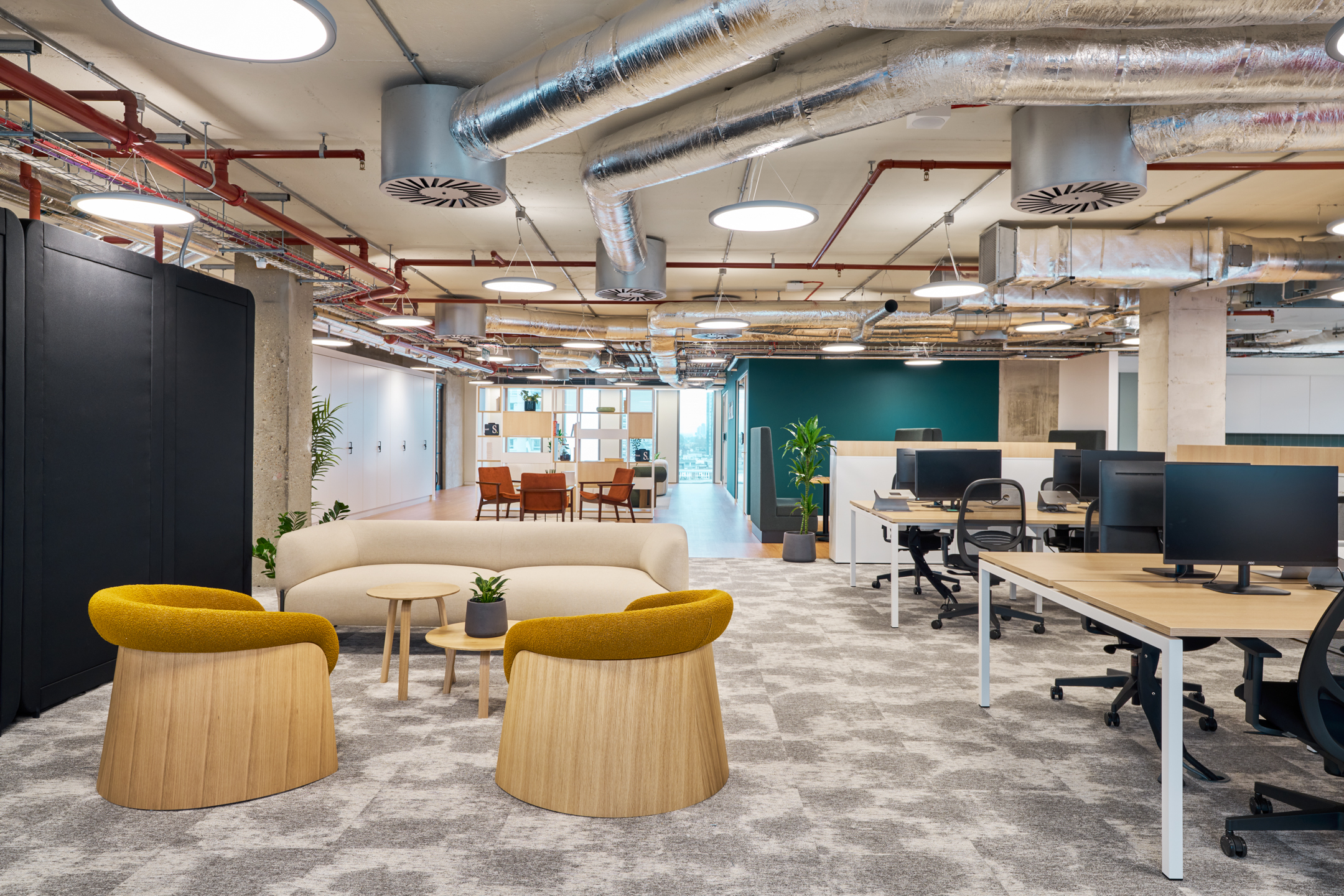 The open-plan workspace in Salesloft’s London office, showcasing collaborative areas with bright, contemporary design and exposed industrial elements.